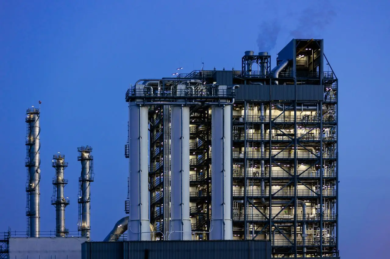 A modern industrial plant in Zuid-Holland captured during twilight with clear skies.